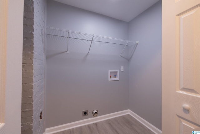 laundry area featuring electric dryer hookup, hookup for a washing machine, and wood-type flooring