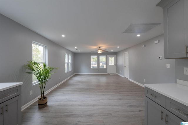 interior space featuring ceiling fan, a wealth of natural light, and light hardwood / wood-style flooring