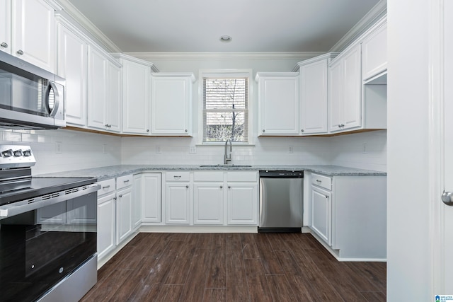 kitchen featuring sink, dark wood-type flooring, stainless steel appliances, light stone counters, and white cabinets