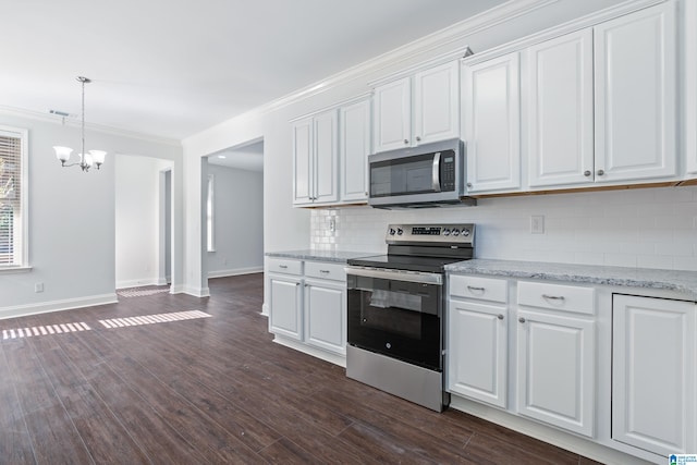 kitchen with light stone countertops, dark hardwood / wood-style flooring, ornamental molding, stainless steel appliances, and white cabinets