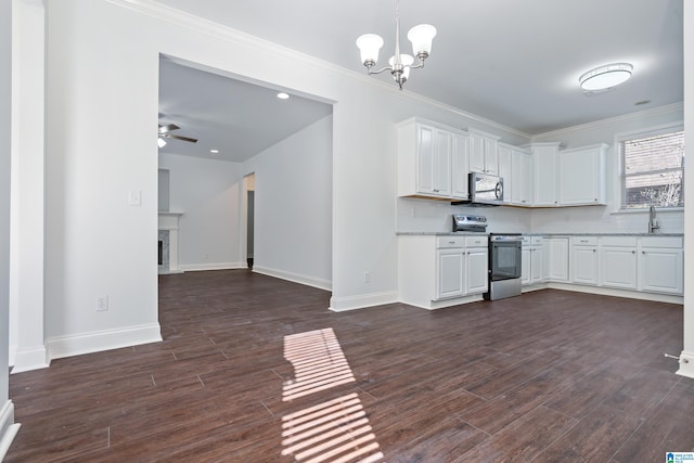 kitchen featuring dark wood-type flooring, ceiling fan with notable chandelier, ornamental molding, white cabinetry, and stainless steel appliances