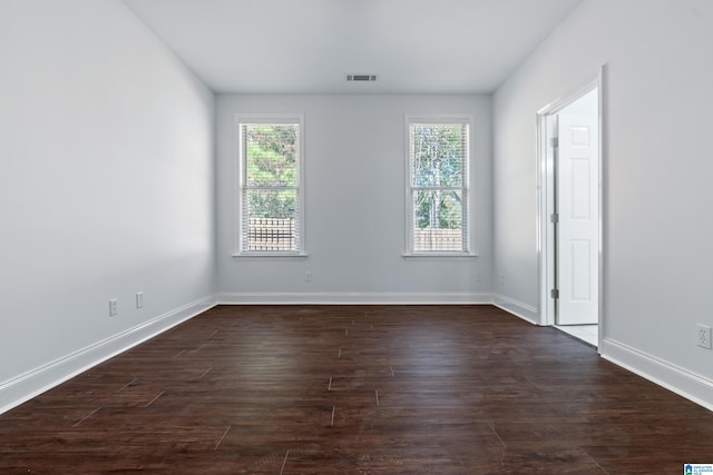 spare room with dark hardwood / wood-style flooring