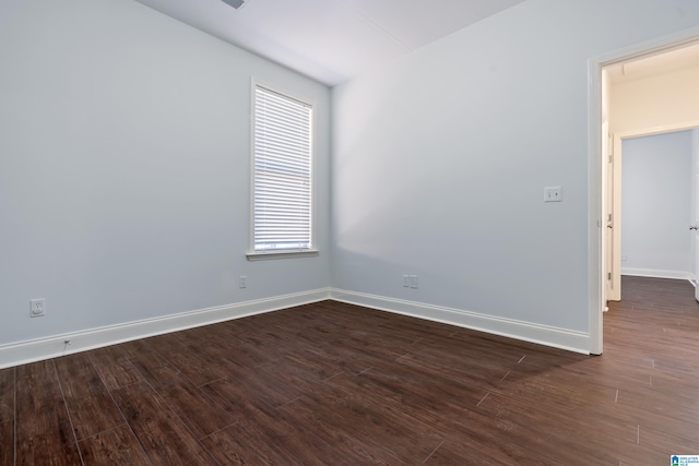 spare room featuring dark hardwood / wood-style floors