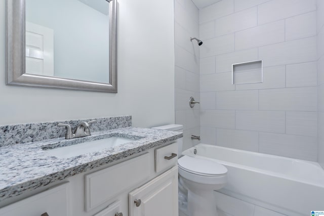 full bathroom featuring vanity, toilet, and tiled shower / bath combo