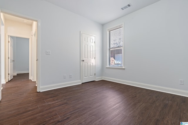 spare room with dark hardwood / wood-style floors