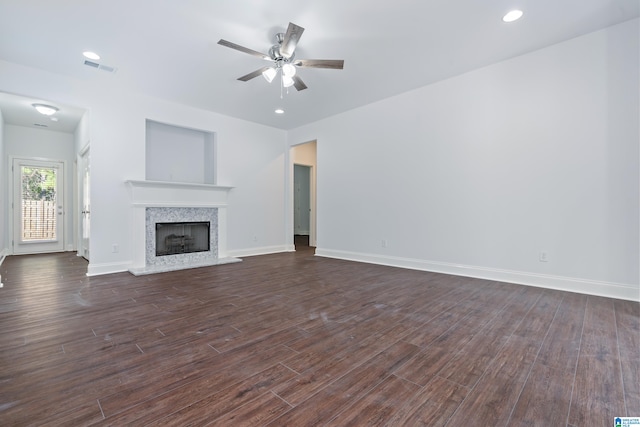 unfurnished living room featuring dark hardwood / wood-style floors and ceiling fan