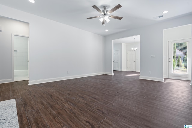 unfurnished living room with dark hardwood / wood-style flooring and ceiling fan with notable chandelier