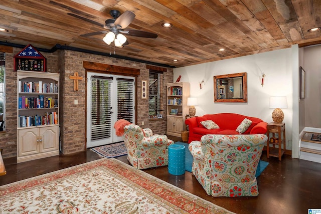 living room featuring ceiling fan, wooden ceiling, and brick wall