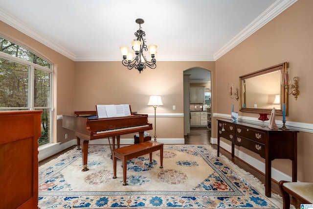 miscellaneous room featuring ornamental molding and a chandelier