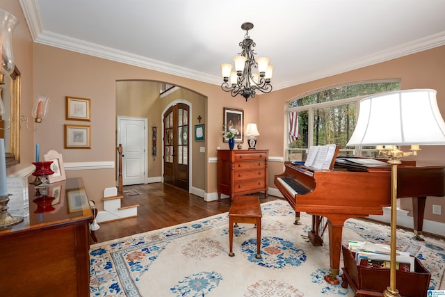 misc room with dark hardwood / wood-style floors, crown molding, and a notable chandelier