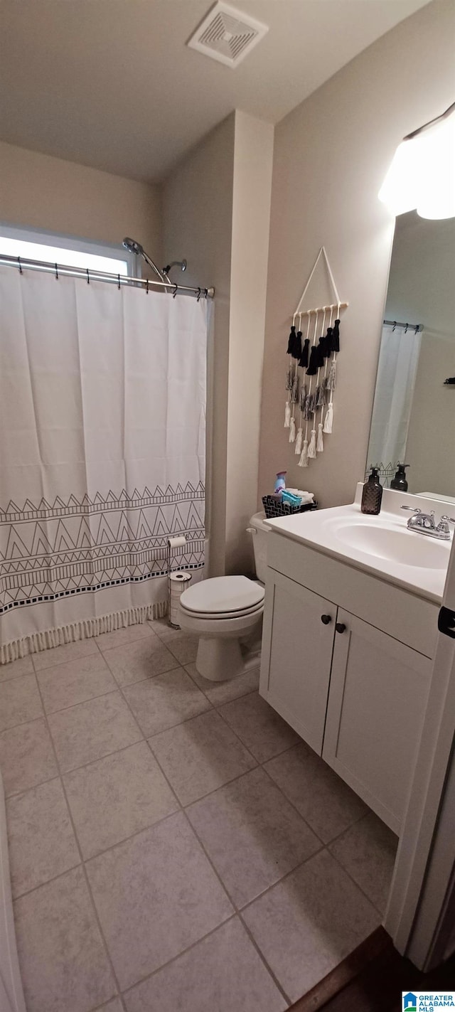 full bathroom with curtained shower, visible vents, toilet, vanity, and tile patterned floors