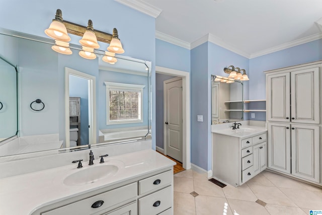 bathroom featuring tile patterned floors, vanity, ornamental molding, and a washtub