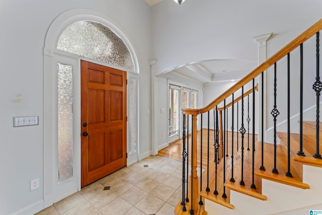 entryway with ornate columns and light tile patterned flooring