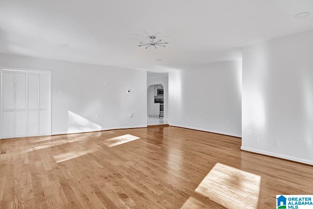 empty room featuring ceiling fan and light wood-type flooring