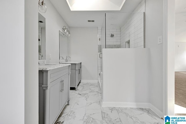 bathroom with vanity and a shower with door