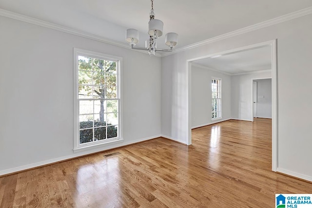 unfurnished dining area featuring ornamental molding, wood-type flooring, and a notable chandelier