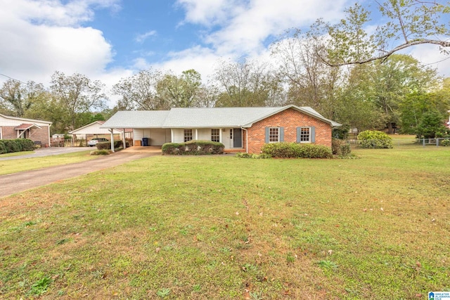 ranch-style home featuring a carport and a front lawn