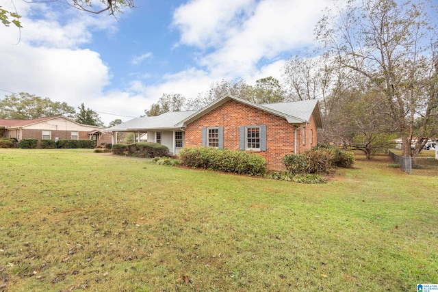 view of side of home with a yard