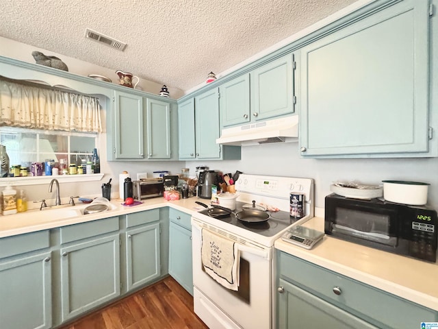 kitchen featuring dark hardwood / wood-style flooring, electric stove, sink, and a textured ceiling