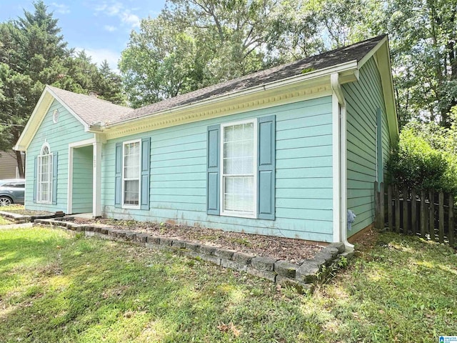 view of side of home with a lawn