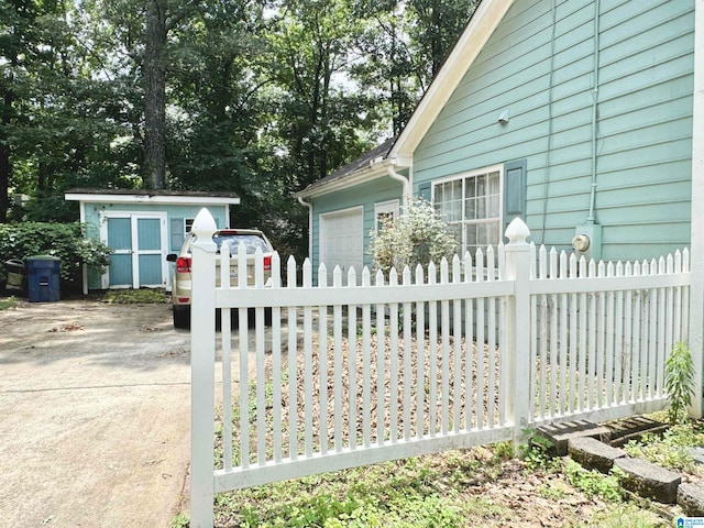 view of gate featuring a storage unit