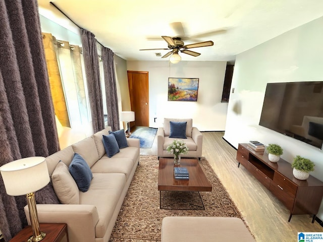 living room with ceiling fan and light hardwood / wood-style floors