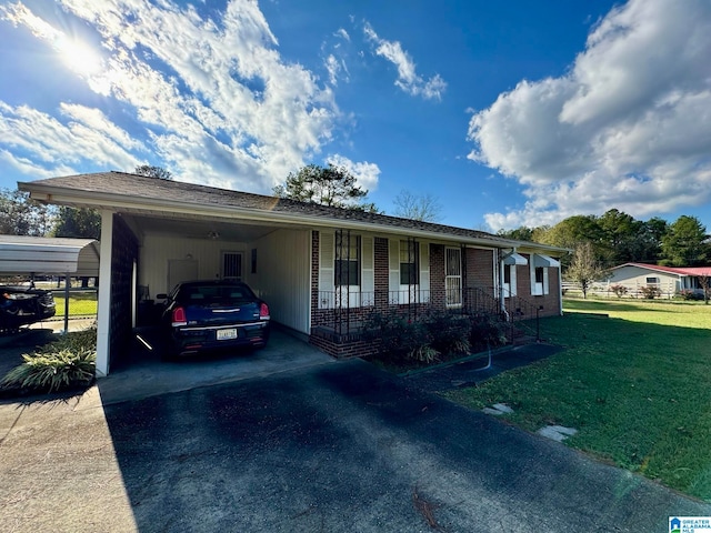 ranch-style home with a carport, a porch, and a front yard