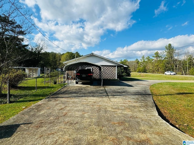 view of side of property with a lawn and a carport