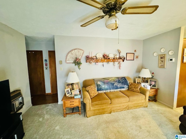 carpeted living room with ceiling fan