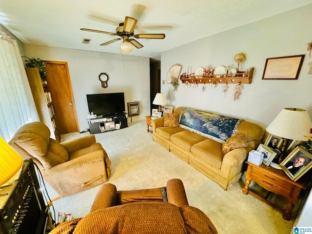 living room with ceiling fan, carpet floors, and heating unit