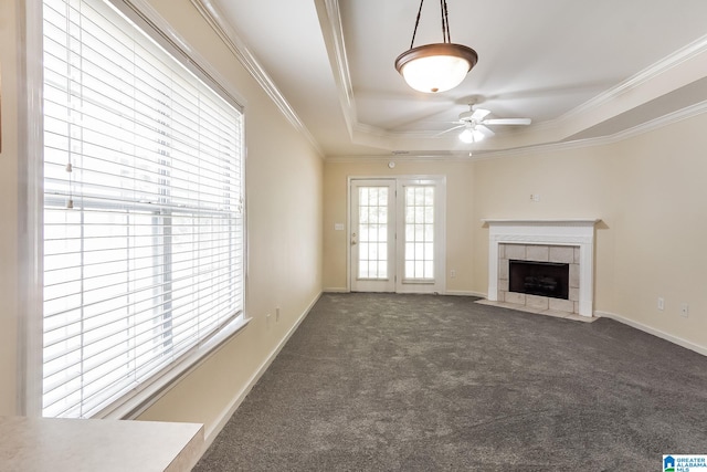 unfurnished living room with a raised ceiling, a fireplace, and dark colored carpet