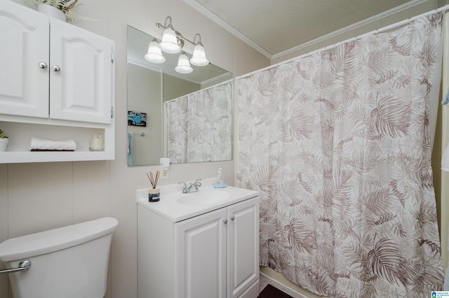 bathroom featuring a textured ceiling, vanity, toilet, and ornamental molding