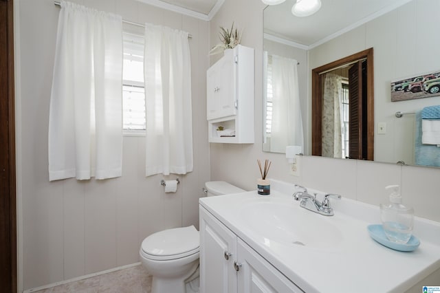 bathroom featuring tile patterned flooring, vanity, toilet, and ornamental molding