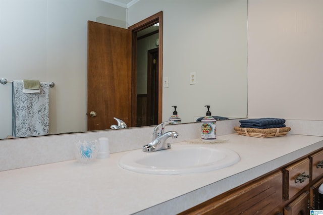 bathroom with vanity and ornamental molding