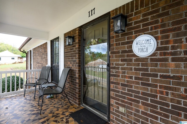 entrance to property featuring covered porch