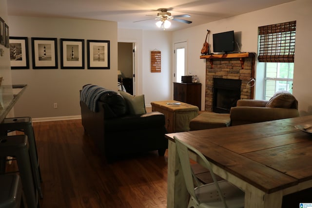 living room with ceiling fan, dark hardwood / wood-style flooring, and a fireplace