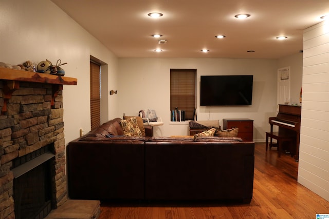 living room with hardwood / wood-style flooring and a fireplace