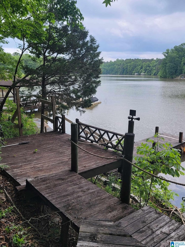 551 Poplar Pl, Wedowee, AL 36278 - deck with a water view, a boat dock, and a view of trees