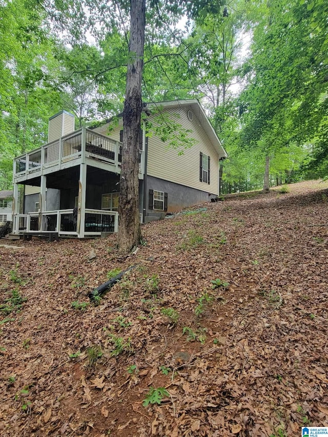 view of home's exterior featuring a wooden deck