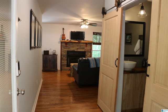 hall featuring a barn door and dark hardwood / wood-style flooring