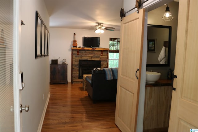551 Poplar Pl, Wedowee, AL 36278 - hallway featuring wood finished floors, a barn door, and baseboards
