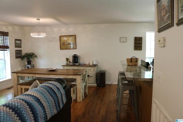 dining room with dark hardwood / wood-style flooring