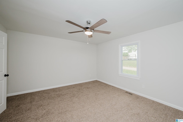 carpeted spare room featuring ceiling fan