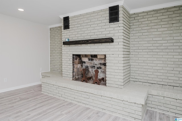 details with a fireplace, wood-type flooring, and crown molding