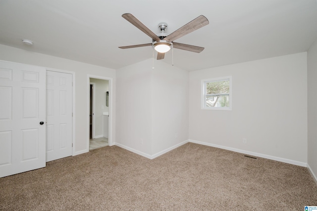 unfurnished bedroom featuring carpet floors, a closet, and ceiling fan