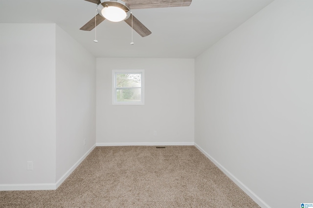 empty room featuring light carpet and ceiling fan