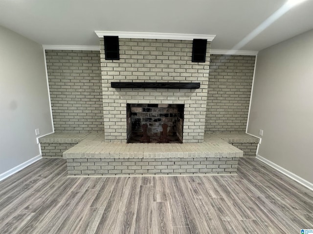 unfurnished living room with crown molding and hardwood / wood-style floors