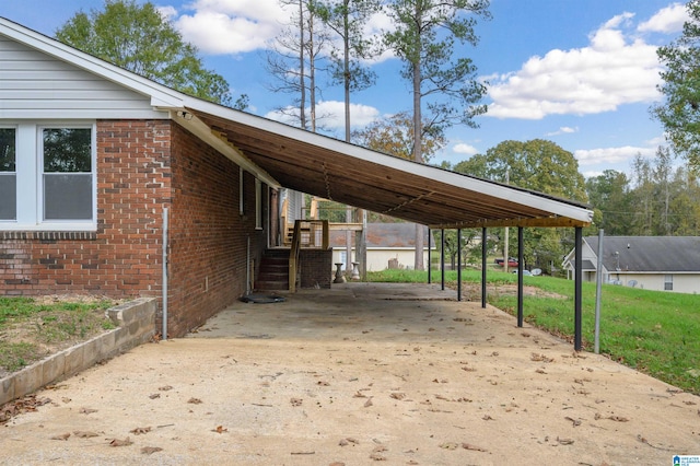 view of parking featuring a yard and a carport