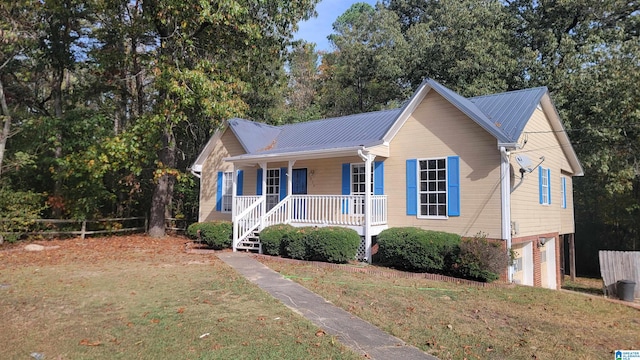 view of front facade with covered porch, a garage, and a front lawn