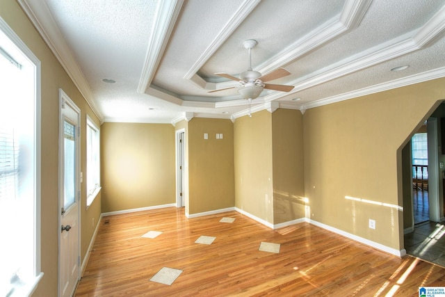 spare room featuring plenty of natural light, a textured ceiling, and ornamental molding